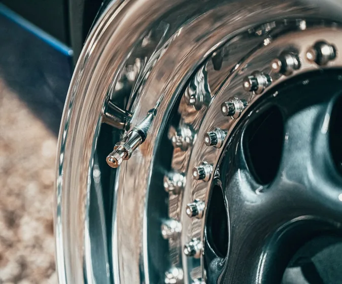 Close-up of a shiny metal brake disc on a car wheel