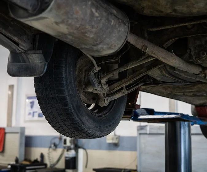 Close-up of a car undercarriage in a service station